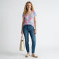 Lynn's Closet Boutique model wearing a pink and blue Lilly Pulitzer Etta V-neck tee with blue jeans and espadrilles.