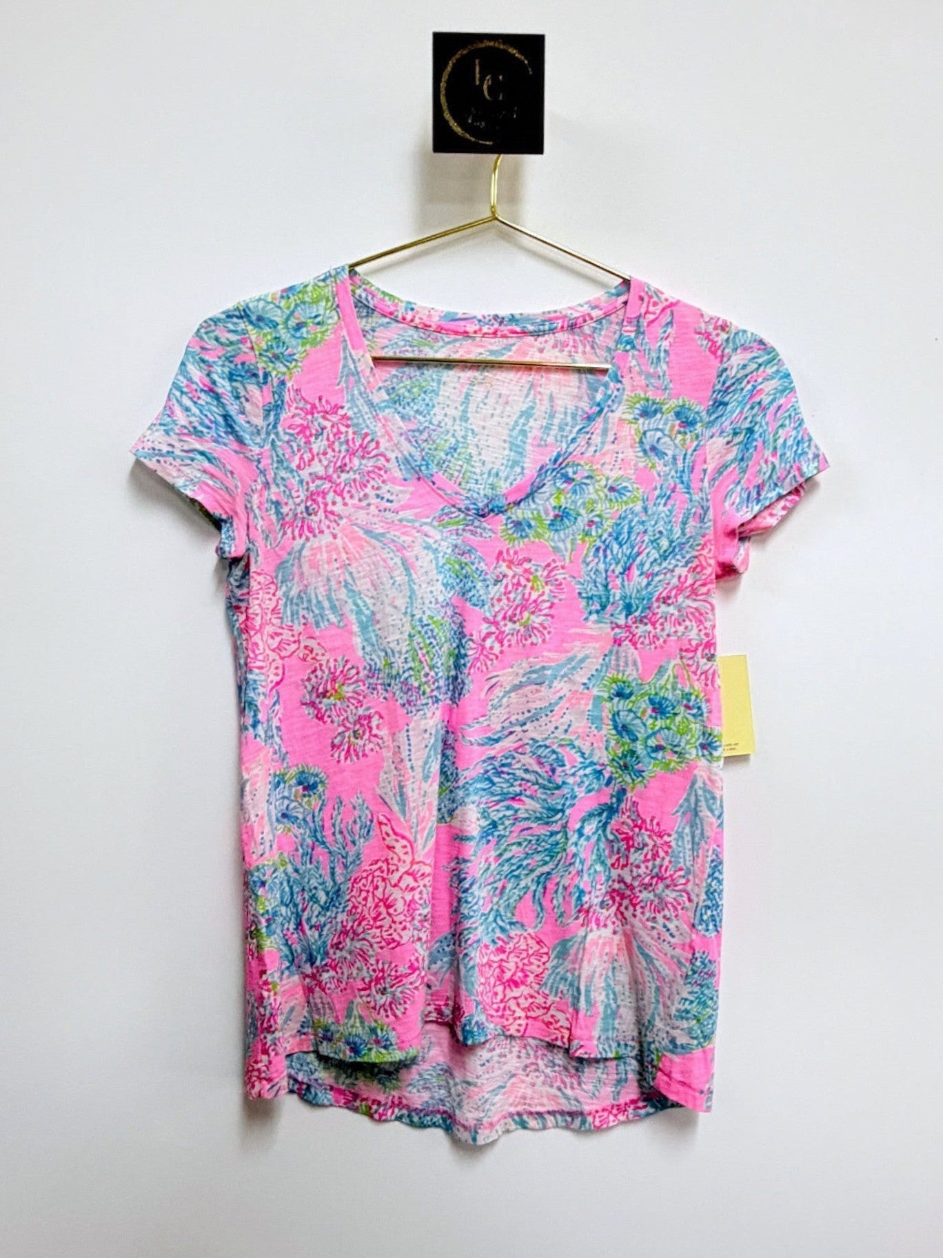 Lynn's Closet Boutique Lilly Pulitzer Etta V-neck tee in a vibrant pink, blue, and green tropical floral print.
