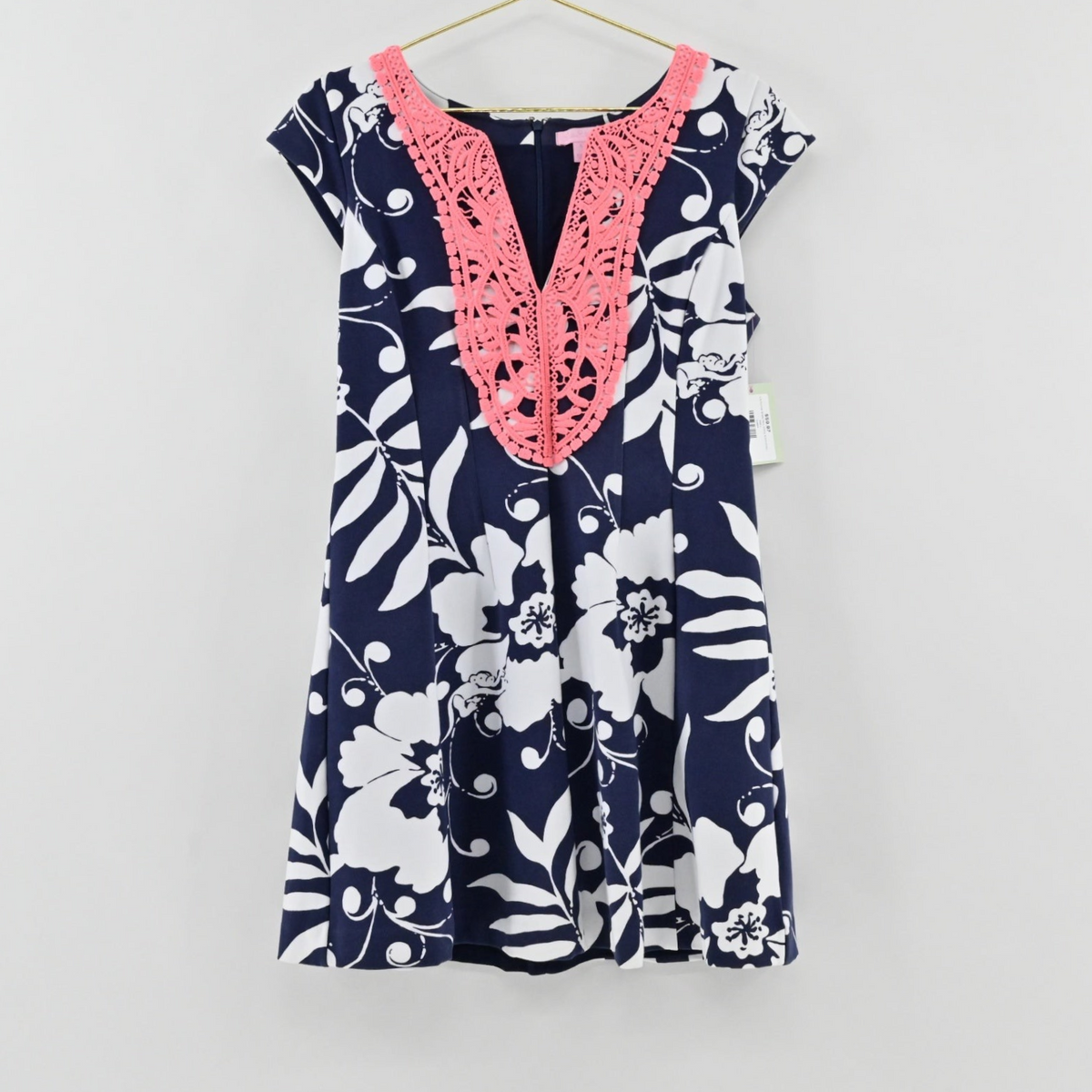 Lynn's Closet Boutique Lilly Pulitzer navy and white floral mini dress with a vibrant coral crochet neckline detail.