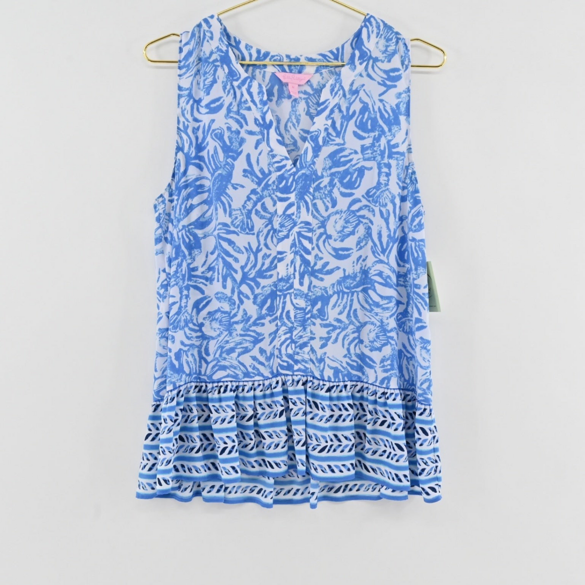 Lynn's Closet Boutique Lilly Pulitzer sleeveless blue and white botanical print peplum top with a V-neckline.