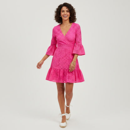 Model wearing a hot pink Lilly Pulitzer Felicity lace dress with bell sleeves from Lynn's Closet Boutique.
