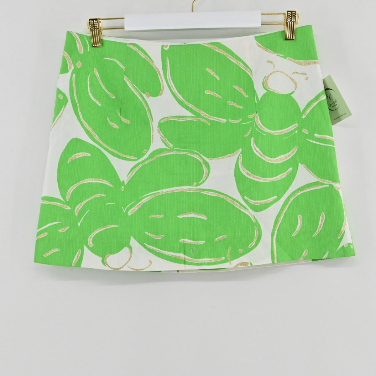 Lynn's Closet Boutique Lilly Pulitzer Tate mini skirt in white with a lime green bee-inspired print on a hanger.