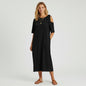 Model wearing a black Lou & Grey cold-shoulder midi dress from Lynn's Closet Boutique with tan sandals.