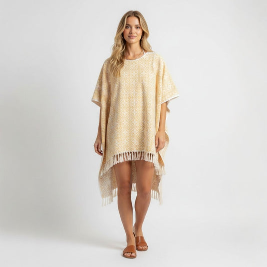 Model wearing a yellow and white Louis Vuitton Monogram Flower Tile beach cape with fringe detail from Lynn's Closet Boutique