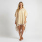 Model wearing a yellow and white Louis Vuitton Monogram Flower Tile beach cape with fringe detail from Lynn's Closet Boutique