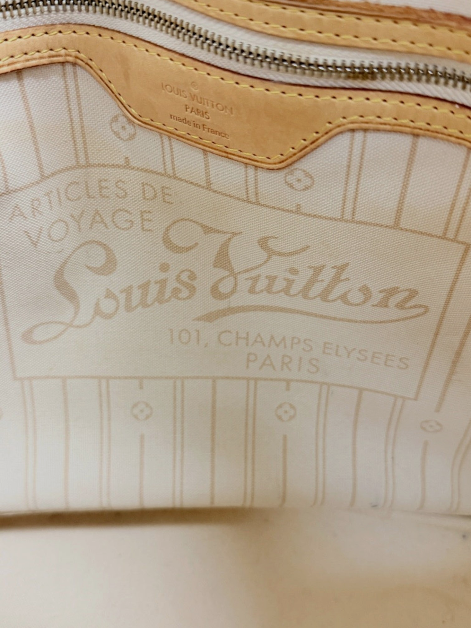 Interior of Lynn's Closet Boutique Louis Vuitton Neverfull MM showing the beige textile lining and leather logo patch