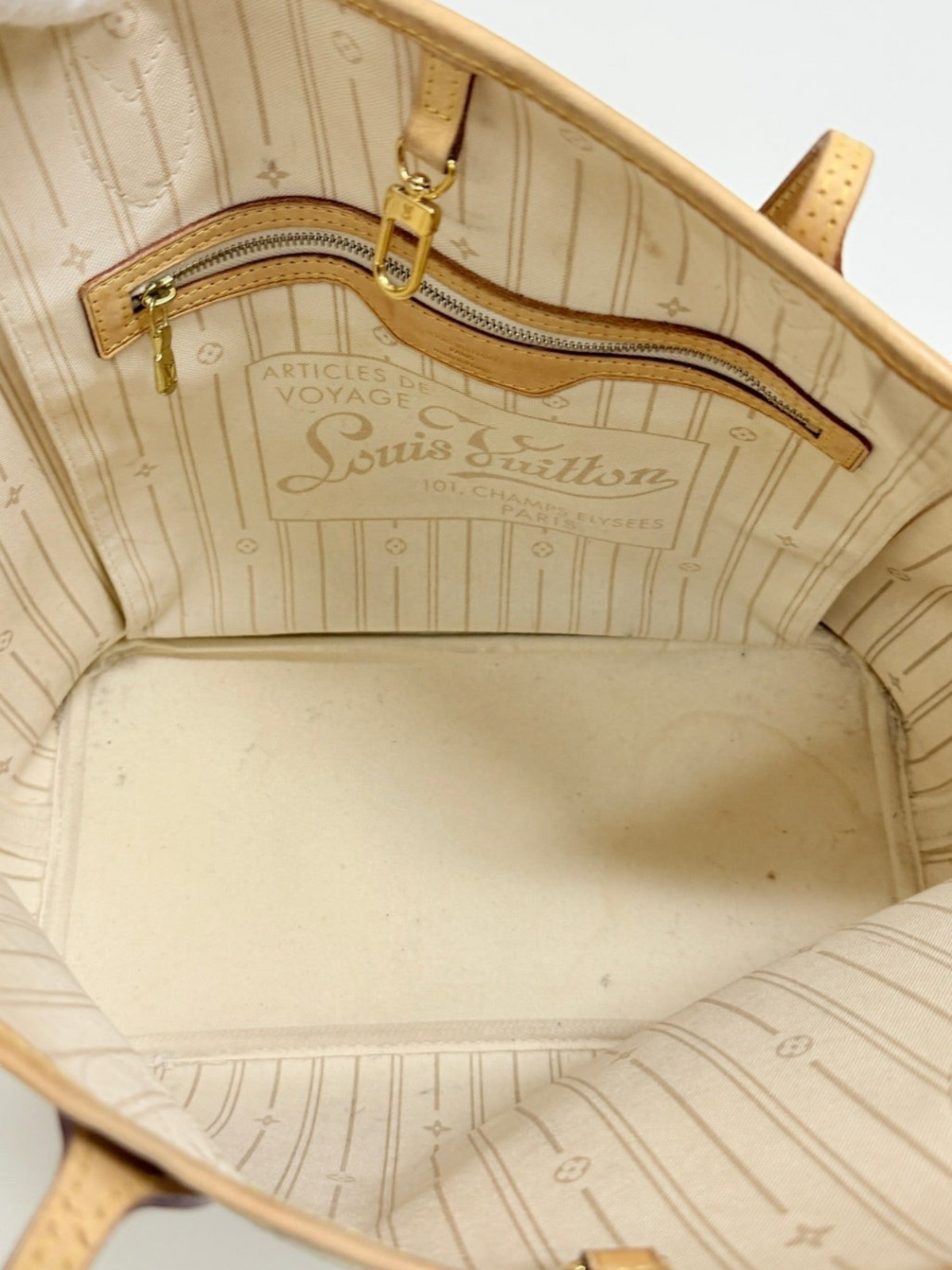 Interior of Lynn's Closet Boutique Louis Vuitton Neverfull MM tote with beige textile lining and gold hardware
