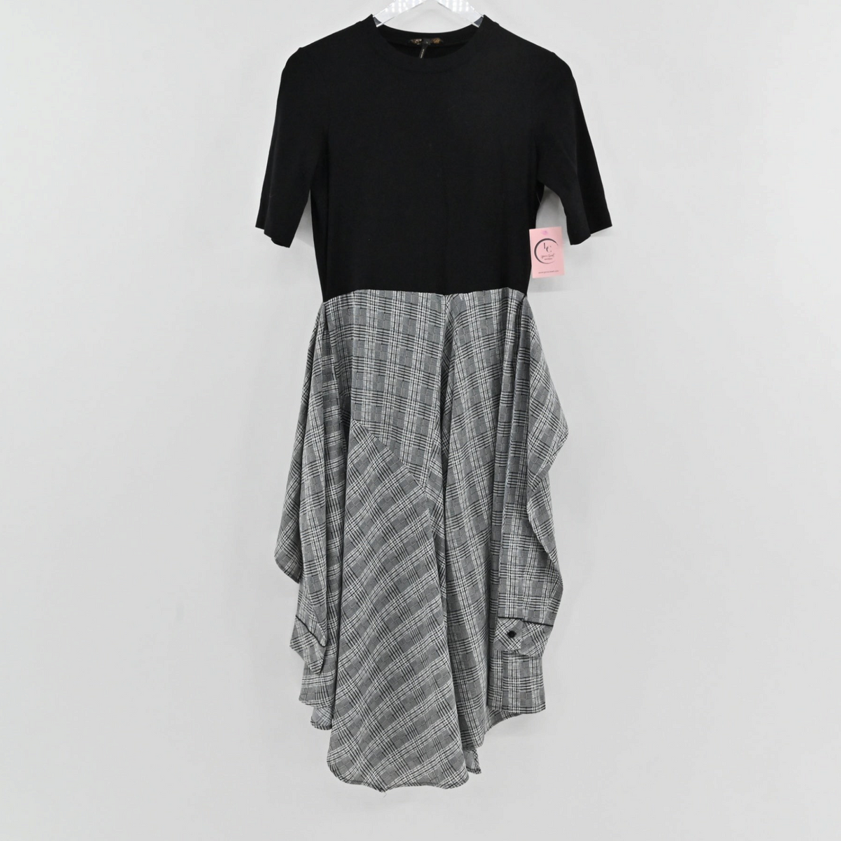 Lynn's Closet Boutique Maje midi dress with a black short-sleeve bodice and an asymmetrical grey checkered skirt.