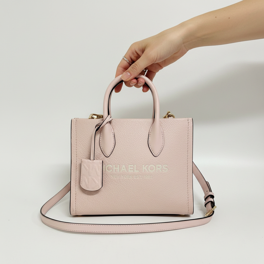 Lynn's Closet Boutique Michael Kors Mirella small blush pebbled leather tote bag held by a hand
