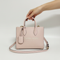 Lynn's Closet Boutique Michael Kors Mirella small blush pebbled leather tote bag held by a hand