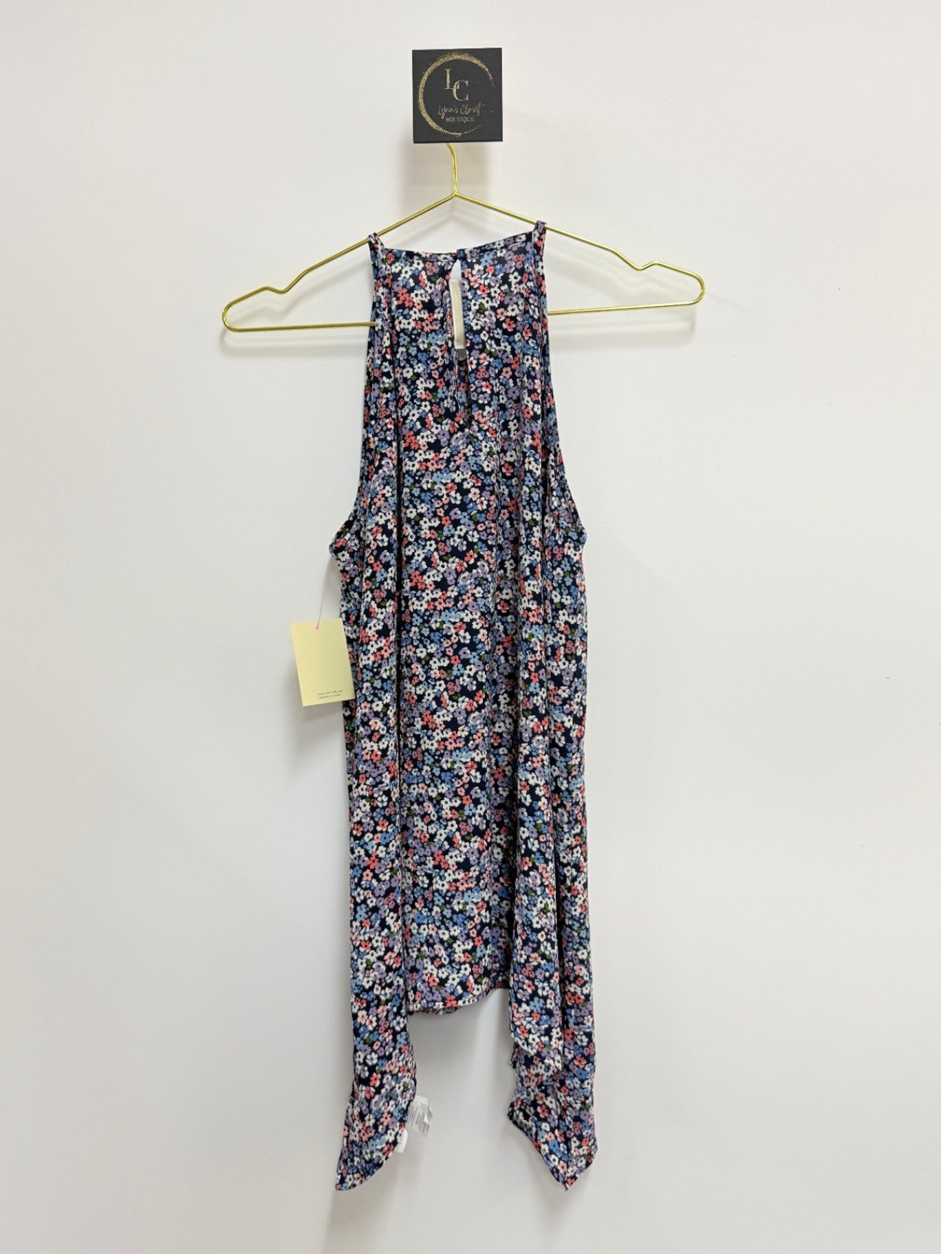 Lynn's Closet Boutique Michael Kors sleeveless floral halter top with a dark background and unique hemline, size S.