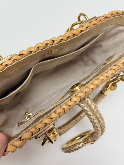 Interior view of a Lynn's Closet Boutique Michael Kors raffia tote with gold leather trim and braided handles.