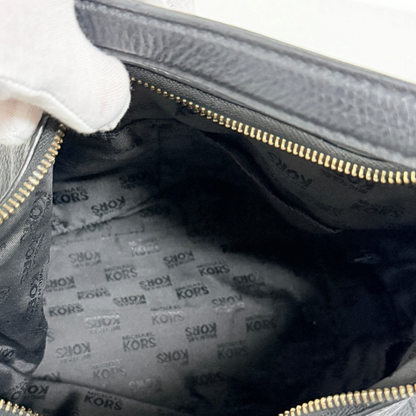 Interior of a Lynn's Closet Boutique Michael Kors black leather tote with signature logo fabric lining and gold zipper