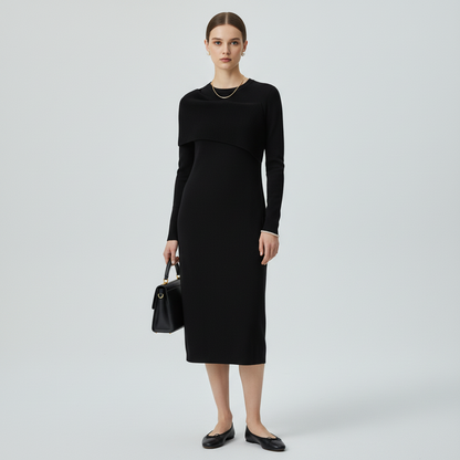 Model wearing a black Misook midi dress with a ribbed collar from Lynn's Closet Boutique, styled with black flats.