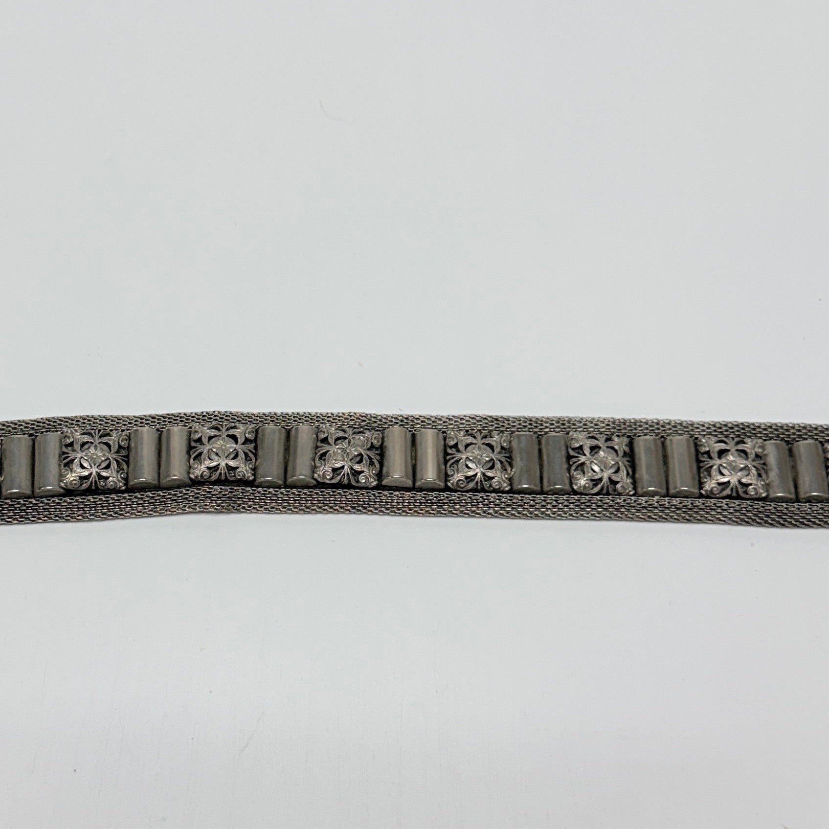 Lynn's Closet Boutique Nanni Italian metallic mesh belt with ornate engraved silver-tone hardware and decorative studs.