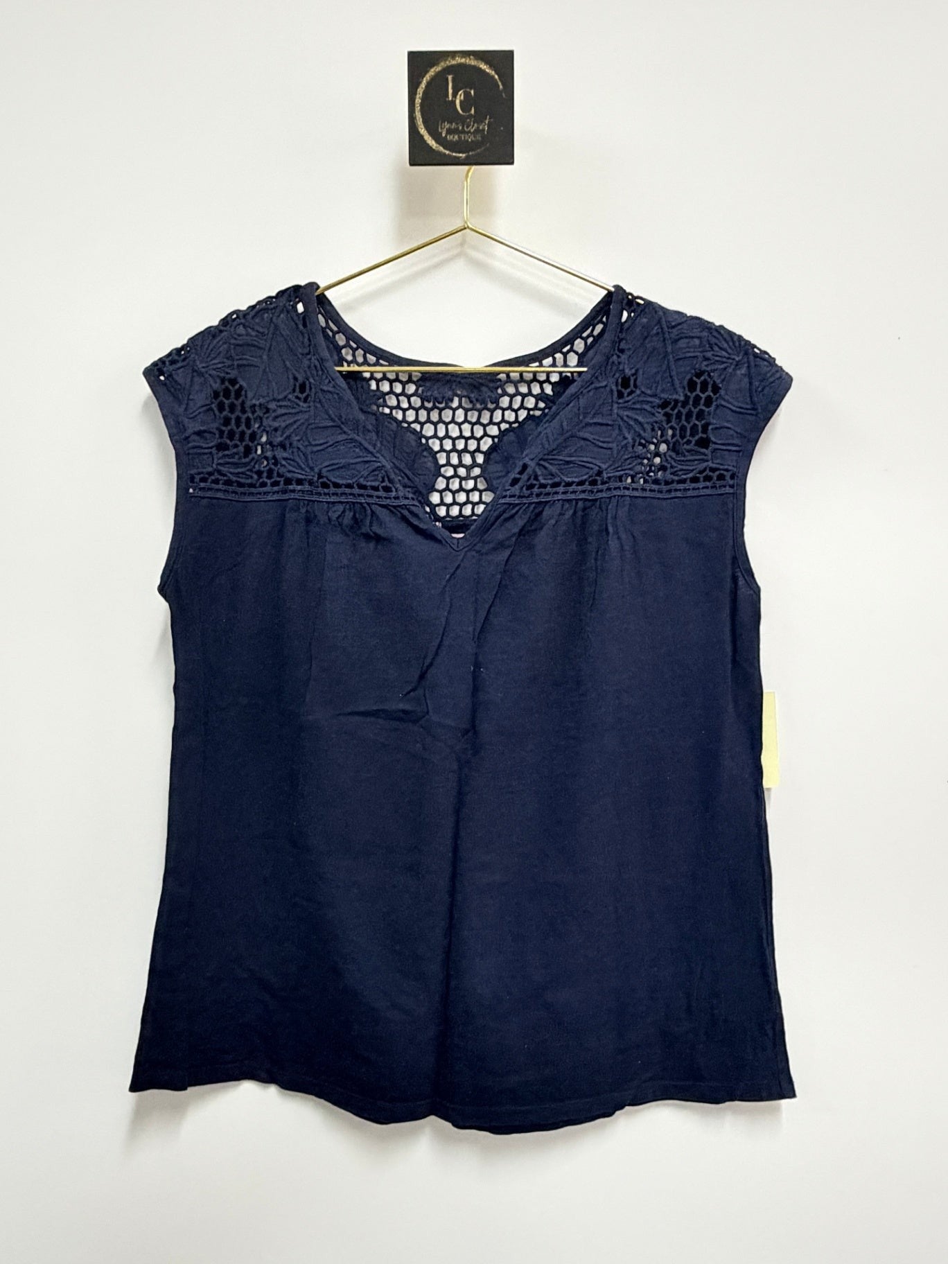 Lynn's Closet Boutique navy blue Lilly Pulitzer sleeveless top with intricate crochet yoke detailing on a hanger.