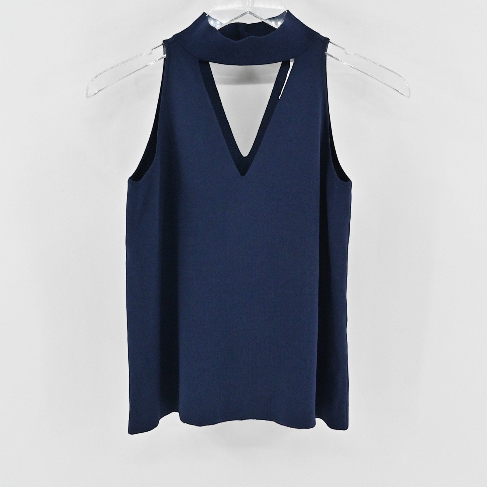 Lynn's Closet Boutique navy sleeveless knit top with a high-neck collar and a modern cutout detail at the chest.