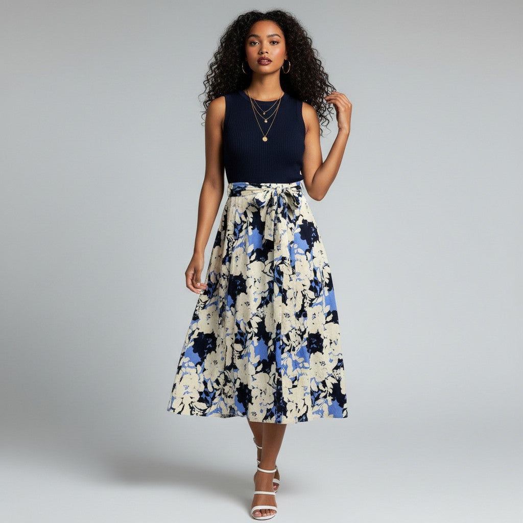 Model wearing a Lynn's Closet Boutique navy knit sleeveless bodice dress with a floral midi skirt and waist tie.