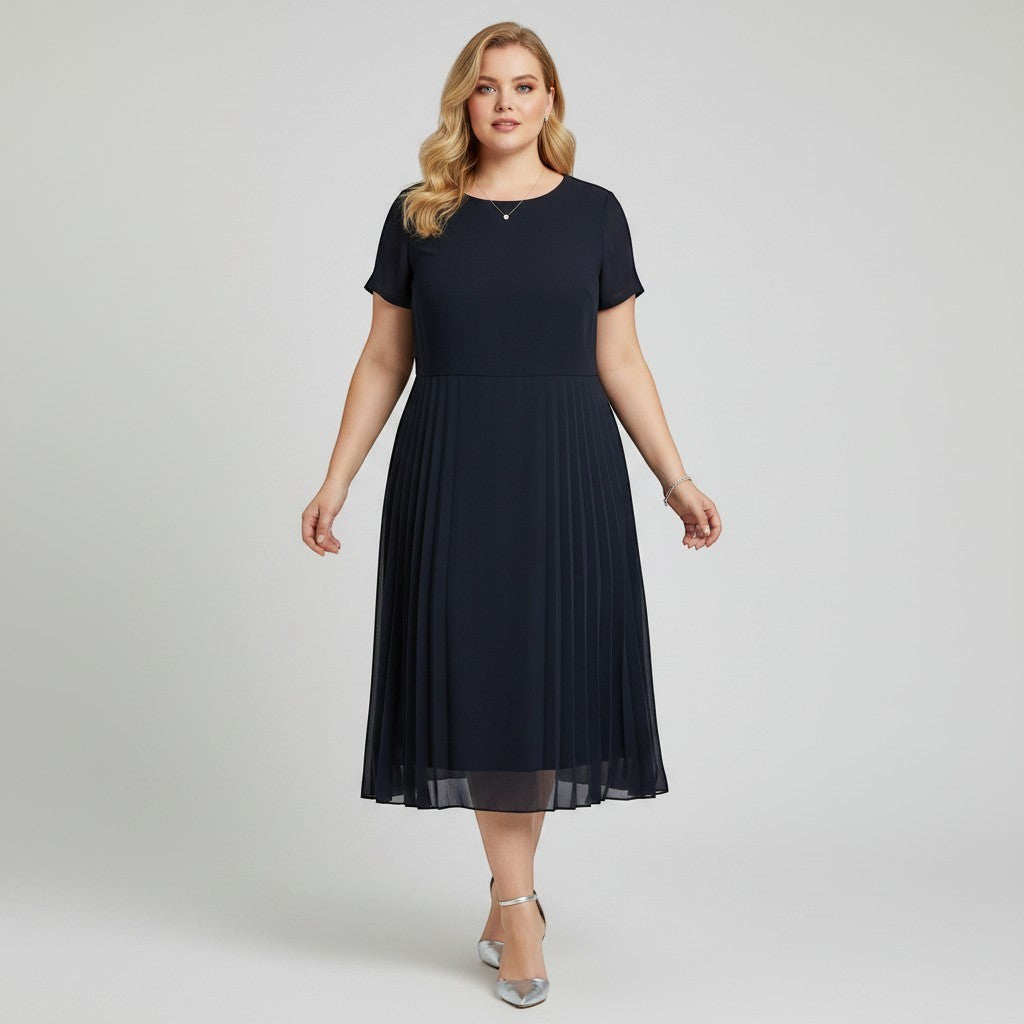 Model wearing a navy Cynthia Howie pleated midi dress from Lynn's Closet Boutique with short sleeves and a round neck.
