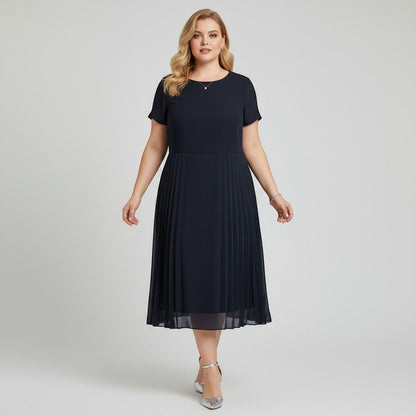 Model wearing a navy Cynthia Howie pleated midi dress from Lynn's Closet Boutique with short sleeves and a round neck.