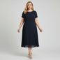 Model wearing a navy Cynthia Howie pleated midi dress from Lynn's Closet Boutique with short sleeves and a round neck.