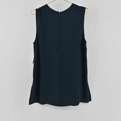 Lynn's Closet Boutique navy blue sleeveless silk top with a back zipper closure hanging on a gold hanger