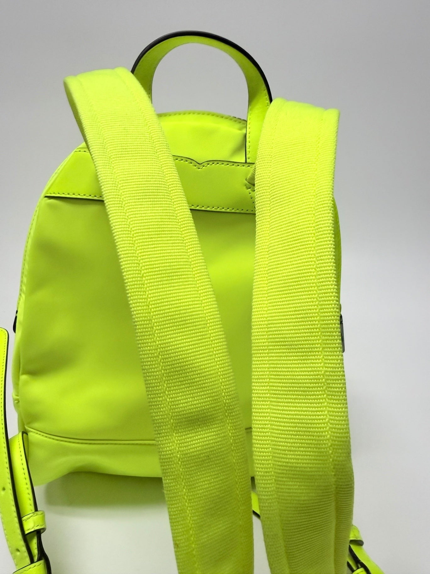 Lynn's Closet Boutique Kate Spade Chelsea neon yellow nylon backpack showing adjustable shoulder straps and top handle