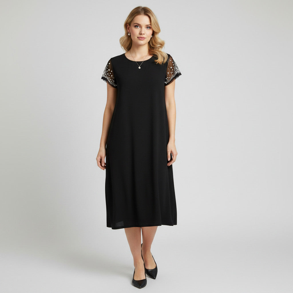 Model wearing a black Nik & Nash midi dress with studded sleeve details from Lynn's Closet Boutique.