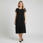 Model wearing a black Nik & Nash midi dress with studded sleeve details from Lynn's Closet Boutique.