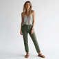 Model wearing Lynn's Closet Boutique Nili Lotan olive green slim-fit utility pants with side-zip ankles