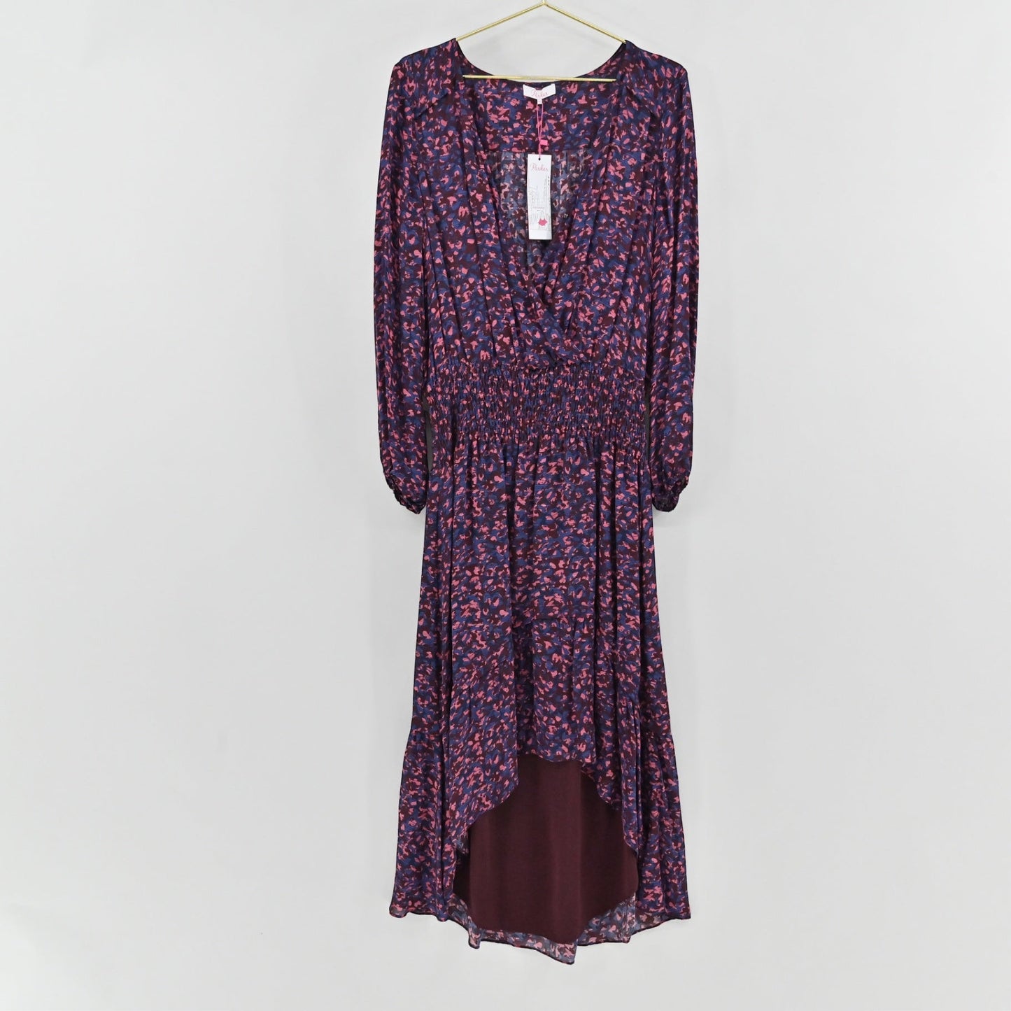 Lynn's Closet Boutique Parker midi dress in deep purple with a pink and blue abstract print, wrap bodice, and high-low hem