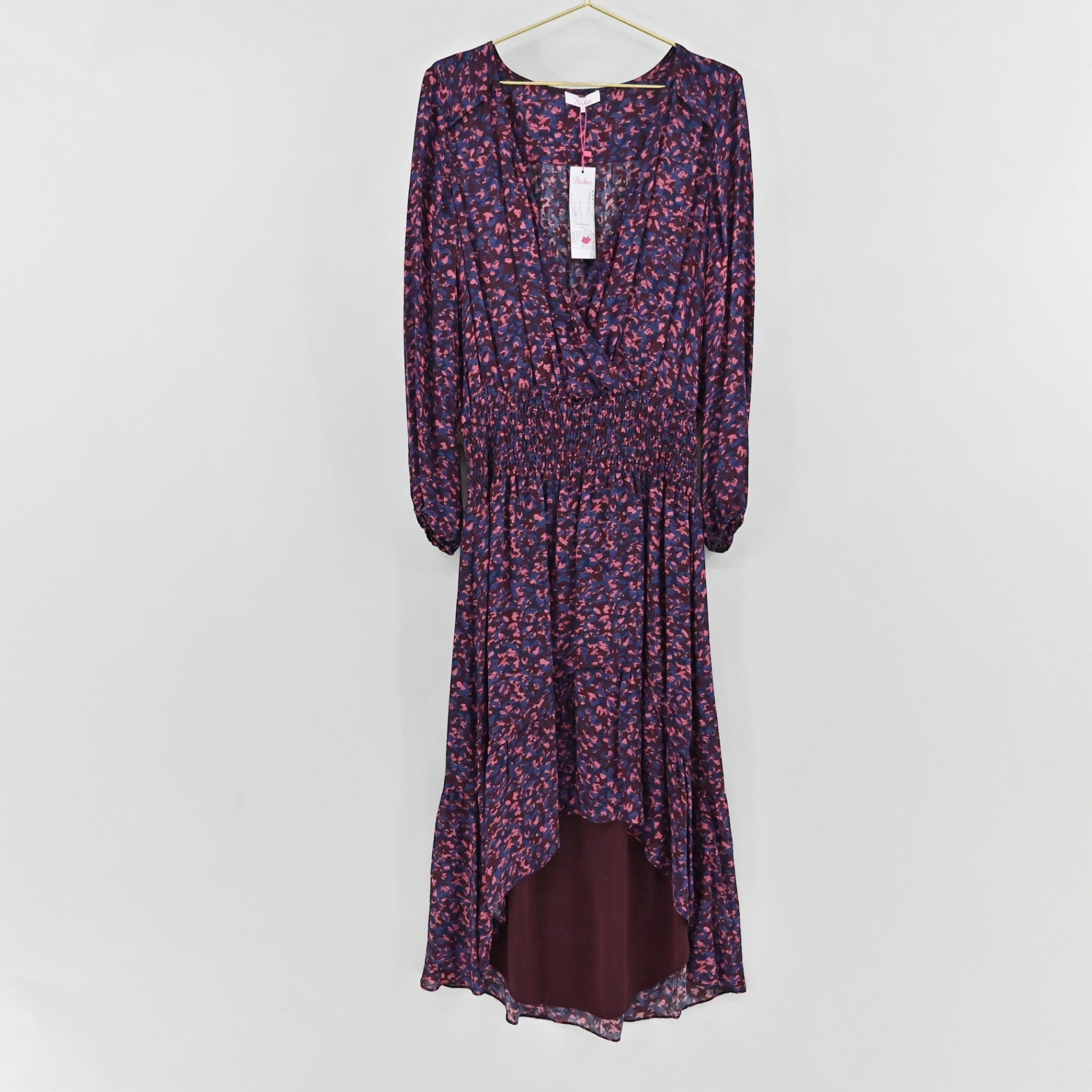 Lynn's Closet Boutique Parker midi dress in deep purple with a pink and blue abstract print, wrap bodice, and high-low hem