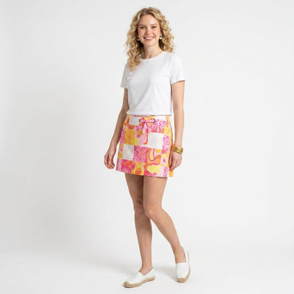 Lynn's Closet Boutique model wearing a Lilly Pulitzer patchwork floral mini skort with a white tee and espadrilles.