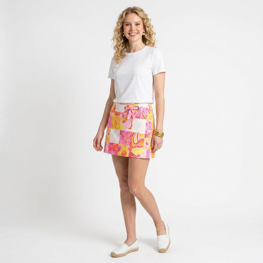 Lynn's Closet Boutique model wearing a Lilly Pulitzer patchwork floral mini skort with a white tee and espadrilles.