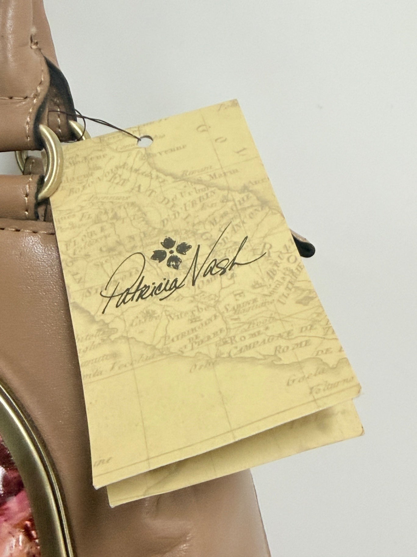 Lynn's Closet Boutique Patricia Nash Angela Satchel brand tag attached to camel leather handbag