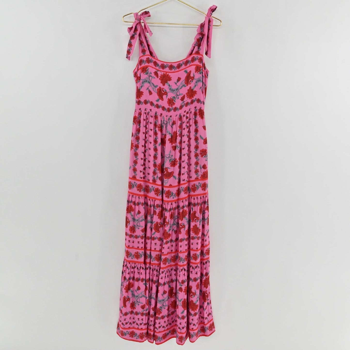 Lynn's Closet Boutique Beach Riot pink floral maxi dress with square neckline, tie straps, and tiered skirt.