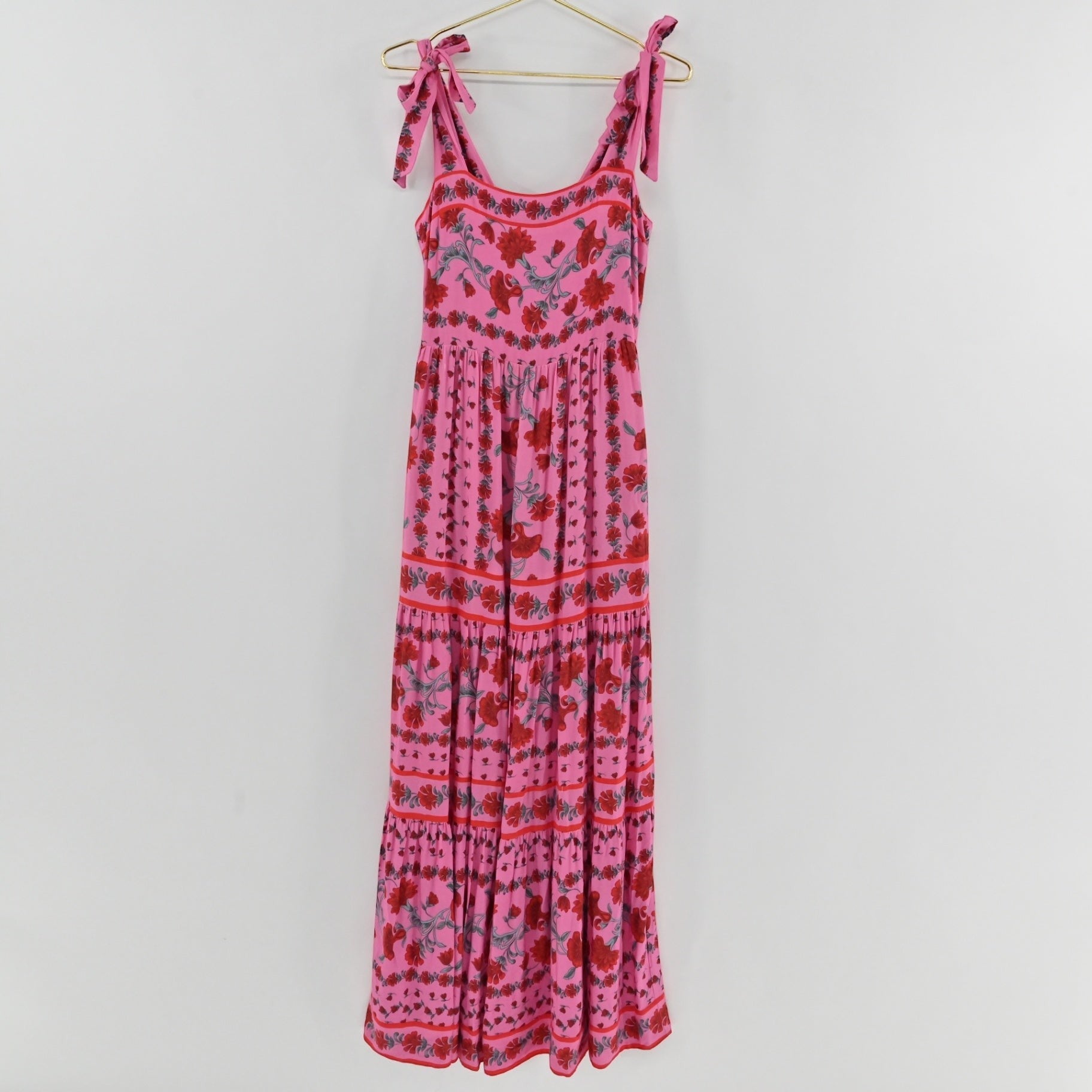 Lynn's Closet Boutique Beach Riot pink floral maxi dress with square neckline, tie straps, and tiered skirt.