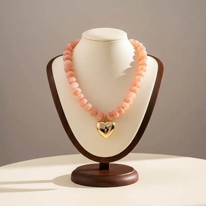 Lynn's Closet Boutique pink acrylic chunky bead necklace with a polished gold-tone heart pendant on a display bust.