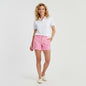 Lynn's Closet Boutique model wearing Lilly Pulitzer Callahan shorts in pink and white grid print with a white polo