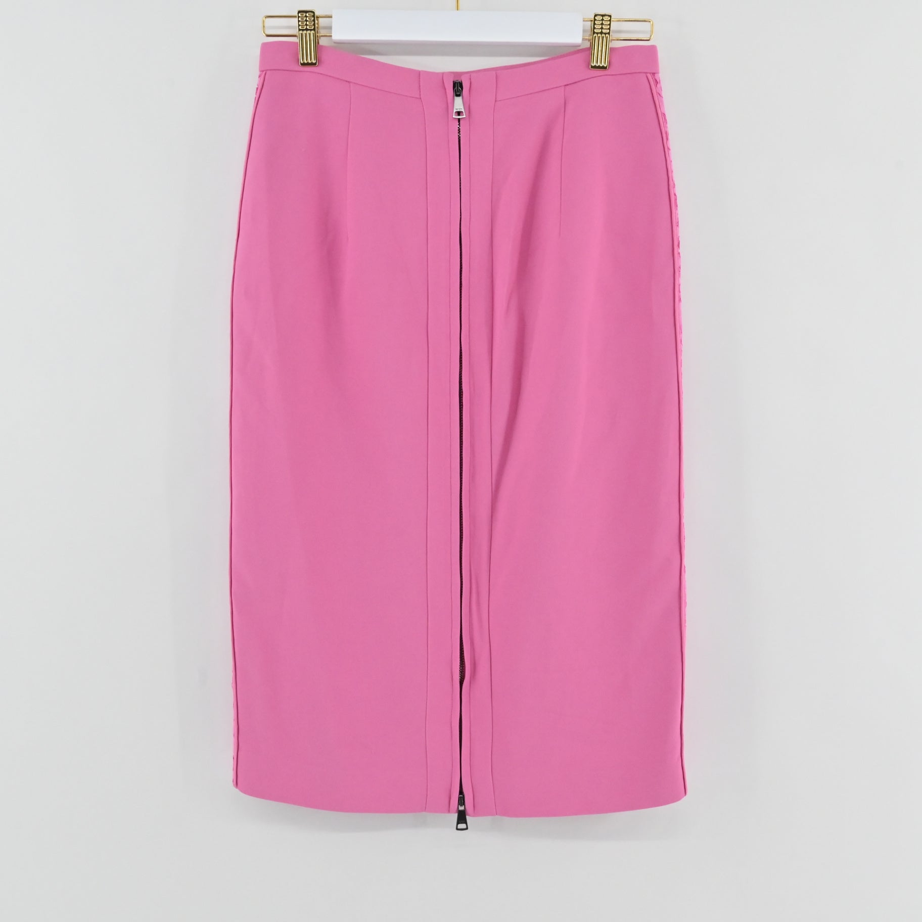 Lynn's Closet Boutique No21 pink pencil skirt with a front zipper closure hanging on a white hanger.