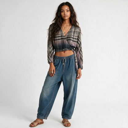 Model wearing Lynn's Closet Boutique Free People plaid wrap top with gradient wash, long sleeves, and cropped fit.