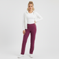 Model wearing Lynn's Closet Boutique purple Lilly Pulitzer leggings with a white zip-up jacket and sneakers