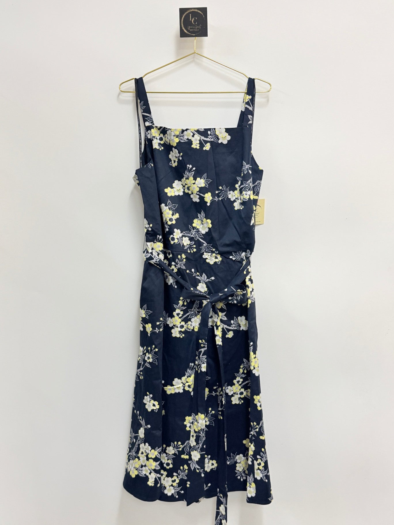 Lynn's Closet Boutique Rachel Roy navy floral midi dress with square neckline, adjustable straps, and waist tie.
