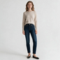Model wearing Lynn's Closet Boutique Rag & Bone dark wash mid-rise slim-leg jeans with a beige sweater and flats.