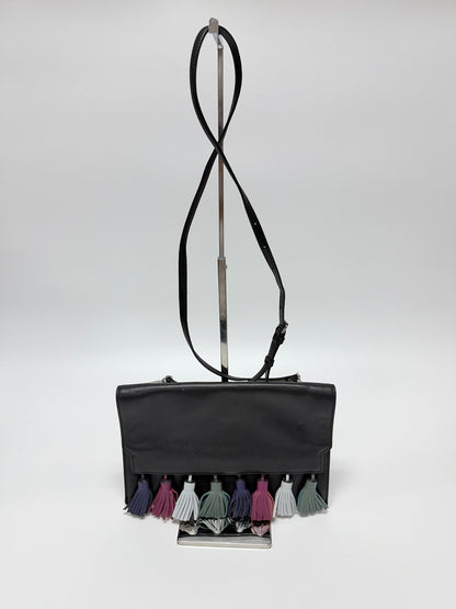 Lynn's Closet Boutique Rebecca Minkoff Sofia black leather clutch with multi-colored suede tassels on a display stand