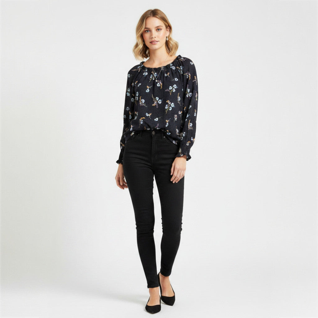 Model wearing a black floral Rebecca Taylor Natalie silk top with long sleeves and black skinny jeans from Lynn's Closet Boutique