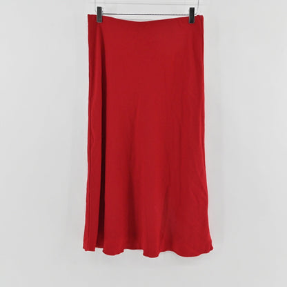 Lynn's Closet Boutique Karen Kane red bias-cut midi skirt hanging against a plain white background.