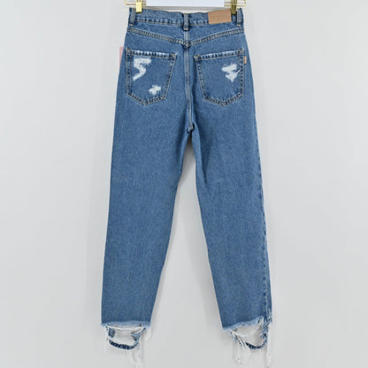 Lynn's Closet Boutique Retrofête medium-blue high-rise distressed jeans with frayed hem, back view.