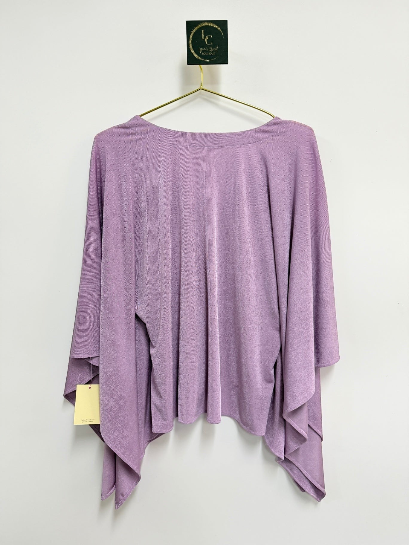 Lynn's Closet Boutique Ripley Rader lilac flowy top with wide sleeves and textured fabric on a hanger
