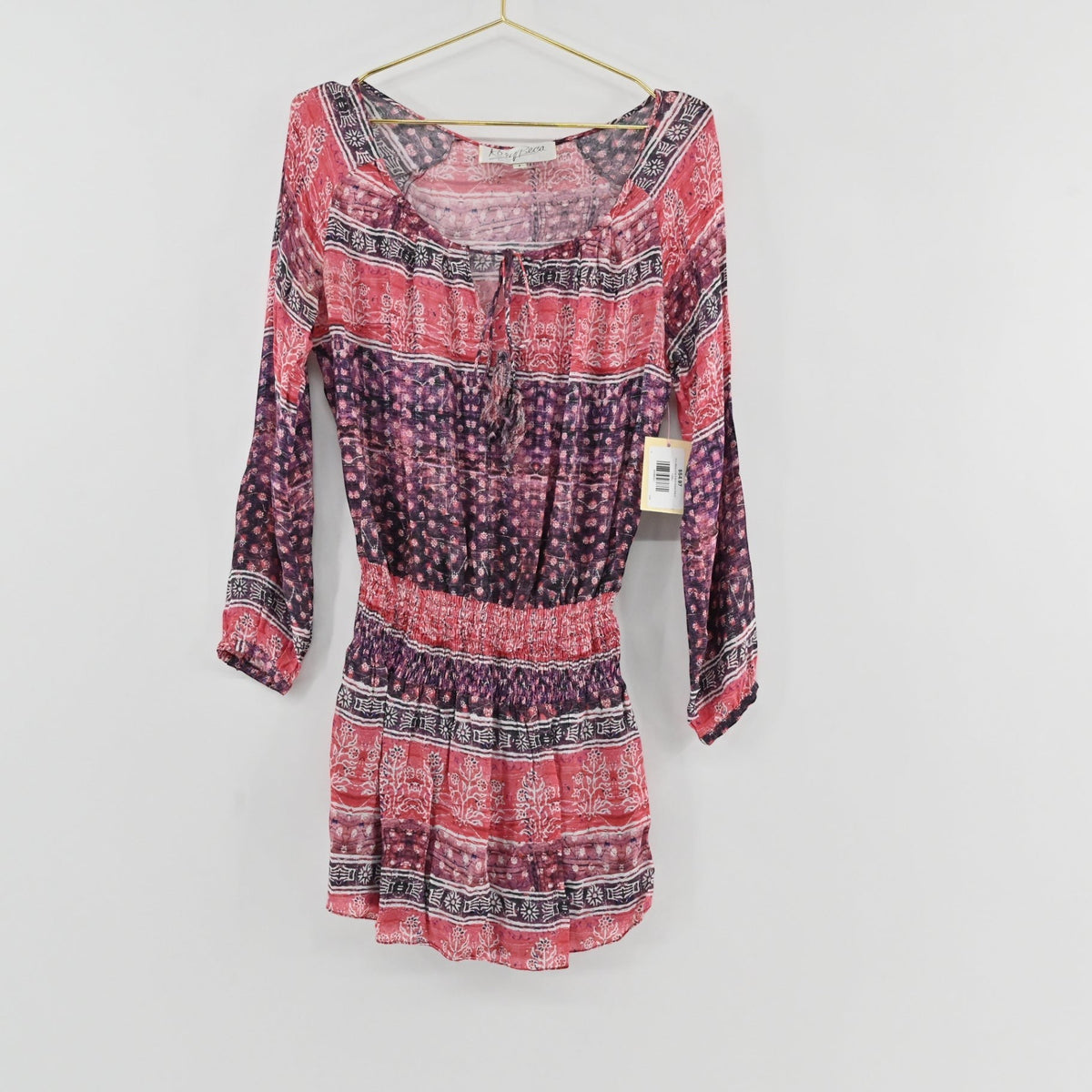 Lynn's Closet Boutique Rory Beca long sleeve bohemian dress in pink, red, and purple with a tie-front neckline.